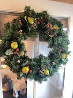 Evergreen wreath with pears, berries, acorns, pinecones