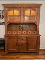 Full view of assembled two-piece hutch showing upper glass cabinet, accessory drawers, lower buffet section