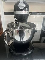 Mixer with bowl and attachments inside