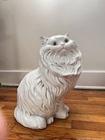 Front view of white glazed ceramic cat figurine