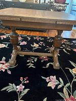 side view showing trestle base and one leaf retracted