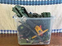 Entire clear bin with assorted G.I. Joe vehicle parts visible