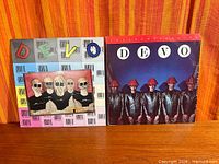 Front covers of both Devo albums side by side