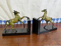 Both bronze horse bookends on tabletop