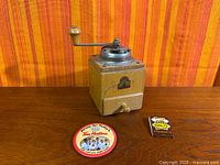 Full view of Armin Trosser coffee grinder with Tim Hortons coaster and matchbook