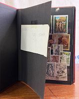 Album inner cover with note 'NUDES 121 STAMPS' and first stock page of artistic stamps