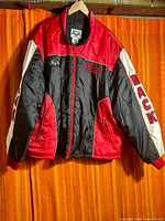 Front view of Mack Trucks jacket hanging, showing color pattern and sleeve logos