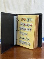 Album open showing mounted bird stamps