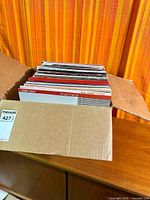 Box filled with upright 12-inch LPs inside cardboard carton