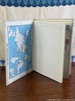 Album opened to first inside page showing map and blank leaf