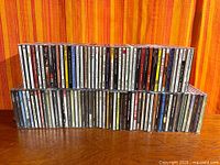 Front view of two rows of CD spines showing quantity and condition