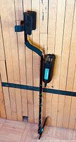 Full view of assembled metal detector leaning against wall
