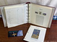 Album open showing mounted stamps, index sheet and Gambia booklet