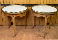 Pair of round side tables showing tops and legs