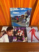 Group shot of vinyl album and three magazines