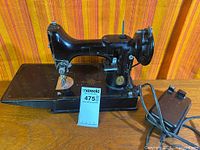 Singer Featherweight 221 sewing machine with foot pedal and power cord, full view left side