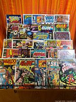 Full lot overview showing all bagged comics spread on table