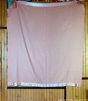 Full blanket hung to show overall size, color, and satin trim edge
