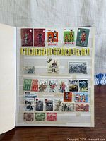 Album page with Antigua soldier stamps and assorted military stamps from various countries