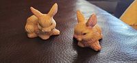 Front view showing both bisque rabbit figurines