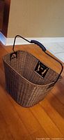 overall view of resin wicker bike basket showing interior and mounting bracket