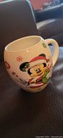 Mug front showing Mickey Santa graphic