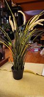 Full view of faux foxtail grass in pot