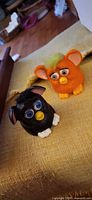 Both 1998 Furby figurines side by side showing size and colors