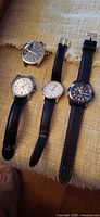 Group shot of four wristwatches with straps displayed