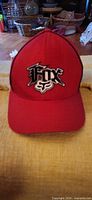 Front view of red Fox Racing hat showing embroidered logo