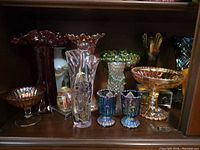 Shelf view showing entire assortment of vases, bowls, compotes and figurine