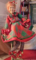 Mae doll in red and green plaid dress with strawberry shoes