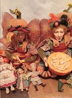 Group shot of both pumpkin fairy dolls and three small vintage dolls