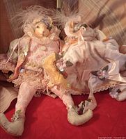 Both Royal Rabbit bunny dolls seated side by side showing full costumes