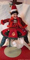 Front view of Katherine Collection holiday jester doll on stand