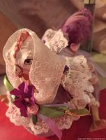 Small purple Victorian style chicken with lace and ribbon details