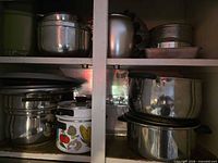 Overall view of both shelves showing cookware and bakeware pieces
