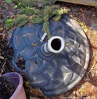 Top view of first umbrella base showing interlaced pattern and pole sleeve