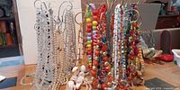 Group view of all necklaces on stands showing quantity and variety