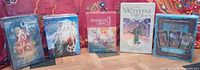 Front view of all five sealed tarot and oracle decks