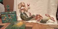 Group shot showing both mermaid plaques, cloisonné box and fused glass plate