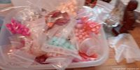 Storage bin showing numerous sealed bags of coloured beads