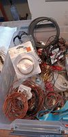 Coils of copper and nickel wire, sealed wire pack, assorted cord within plastic bin