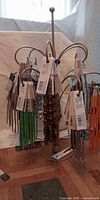 Multiple bead strands hanging on stand, various colours