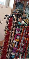 Assorted necklaces and bracelets hanging on display rack