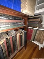 Wooden cabinet with binders of shellac records and LPs