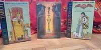 Front view of all three boxed tarot decks