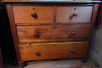 Front view of four-drawer solid wood dresser