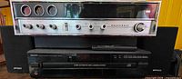 Front view of Panasonic receiver stacked on Denon CD changer with Optimus speakers flanking