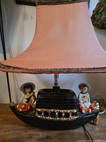 Full lamp with shade showing figurines and base